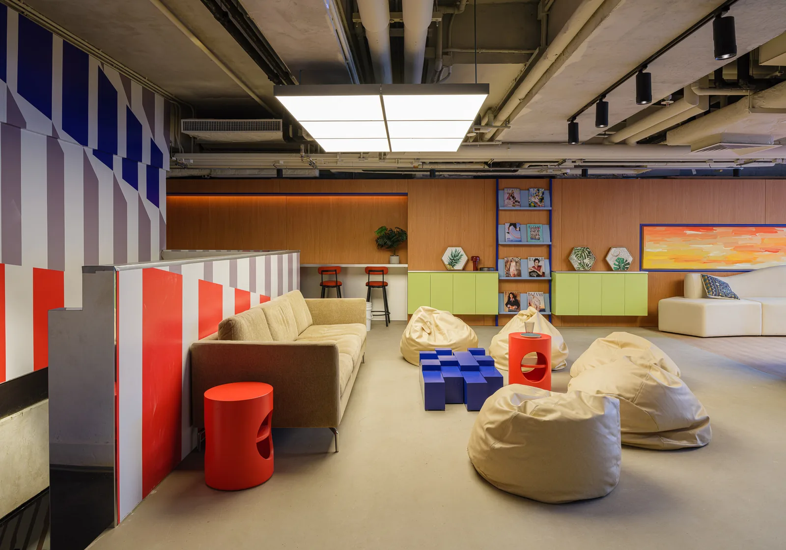 Communal lounge at Stride Wong Chuk Hang with sofas, beanbags and a cobalt coffee table